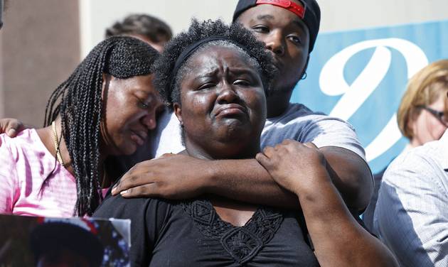 Matrice Stanley center sister of Donnell Thompson who was fatally shot by Los Angeles County Sheriff's deputies in Compton Calif. Thompson's brother Dwayne Hill rear and Antoinette Brown left speak to reporters outside the County Hall