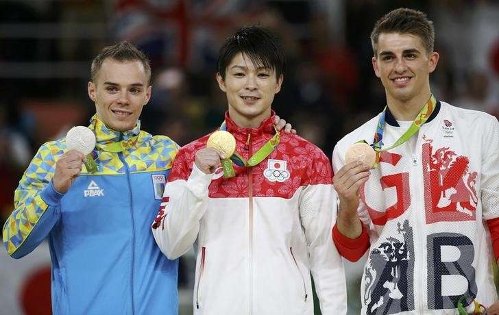 2016 Rio Olympics- Artistic Gymnastics- Men's Individual All Around Victory Ceremony- Rio Olympic Arena- Rio de Janeiro Brazil- 10/08/2016. Gold medallist Kohei Uchimura of Japan, silver medallist Oleg Verniaiev of Ukraine and