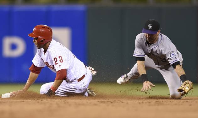 Philadelphia Phillies&#039 Aaron Altherr left reaches second base ahead of Colorado Rockies&#039 Daniel Descalso in the second inning of a baseball game on Friday Aug. 12 2016 in Philadelphia