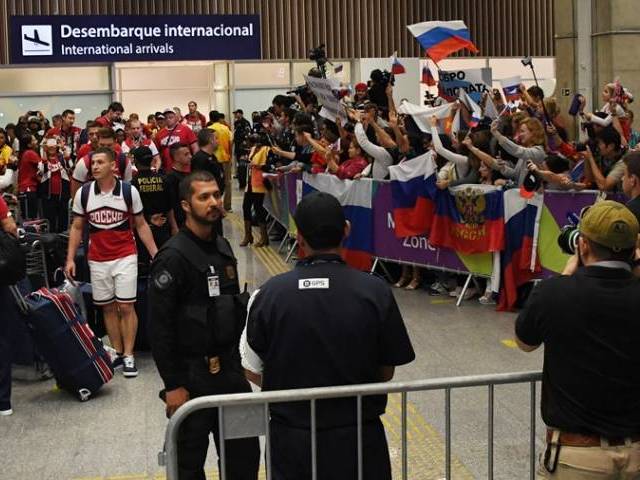 People recieve the Russian Olympic team upon its arrival at the Antonio Carlos Jobim International Airport in Rio de Janeiro Brazil