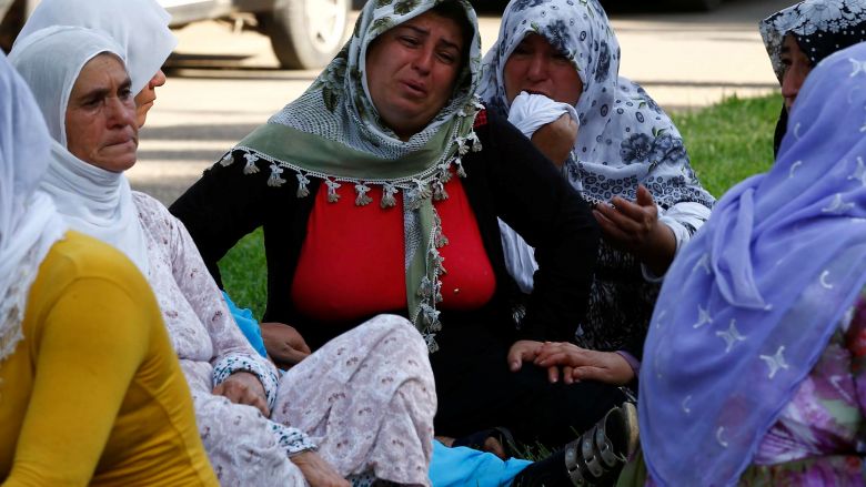 Women mourn as they wait in front of a hospital morgue in the Turkish city of Gaziantep after a suspected bomber targeted a wedding celebration in the city Turkey