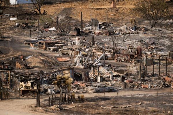 Scorched cars and trailers burned by the Blue