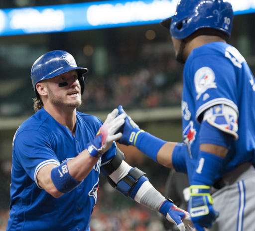 Toronto Blue Jays third baseman Josh Donaldson left celebrates with Edwin Encarnacion after hitting a solo home run against the Houston Astros during the fourth inning of a baseball game Wednesday Aug. 3 2016 in Houston