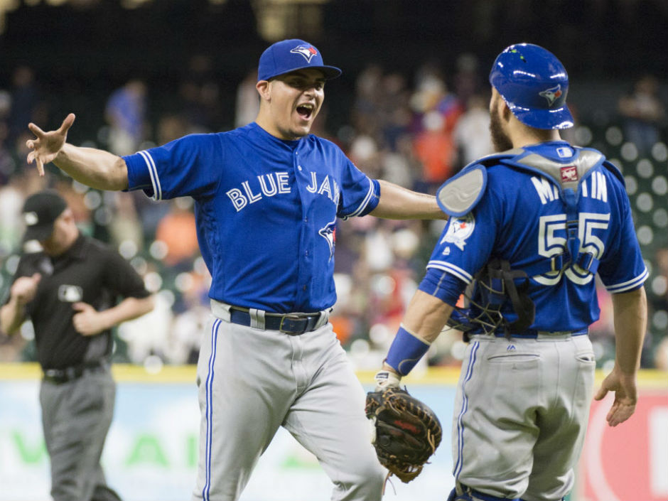 Toronto Blue Jays relief pitcher Roberto Osuna left celebrates with catcher Russell Martin after the 4-1 win over the Houston Astros on Thursday