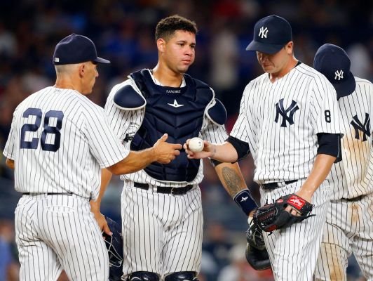 Anthony Swarzak right hands the ball to manager