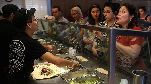 Chipotle restaurant workers fill orders for customers