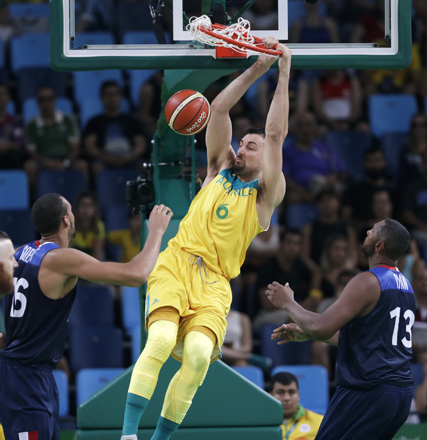 ASSOCIATED PRESS           Australia’s Australia’s Andrew Bogut dunks the ball over France’s Rudy Gobert left and Boris Diaw right during a basketball game at the 2016 Summer Olympics in Rio de Janeiro Brazil Saturday