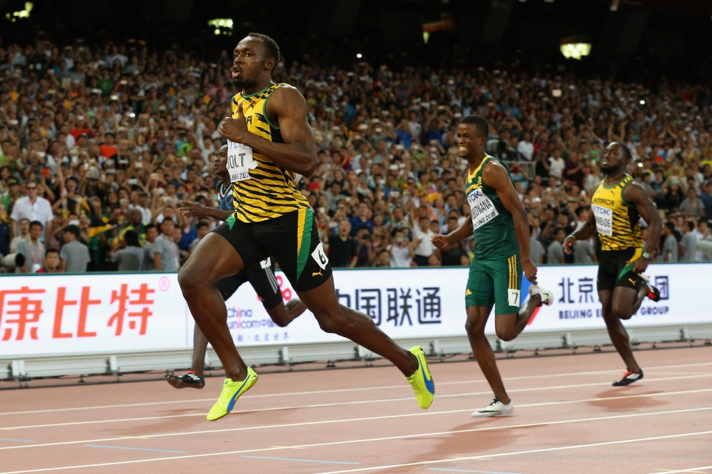 BEIJING CHINA- AUGUST 27 Usain Bolt of Jamaica crosses the finish line to win gold ahead of Anaso Jobodwana of South Africa in the Men's 200 metres final during day six of the 15th IAAF World Athletics Championships Beijing 2015 at Beijing Nati