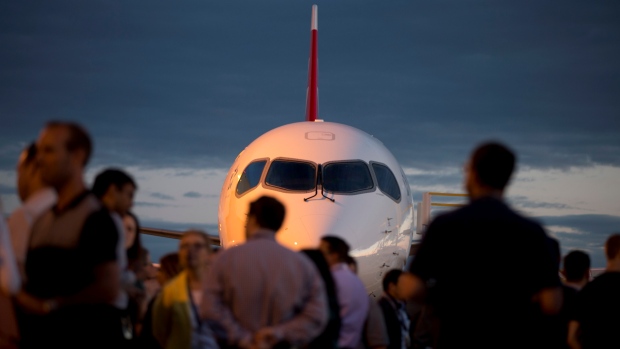 Bombardier employees watch as a CSeries aircraft is rolled out to mark the first delivery to Swiss International Air Lines in Mirabel Que