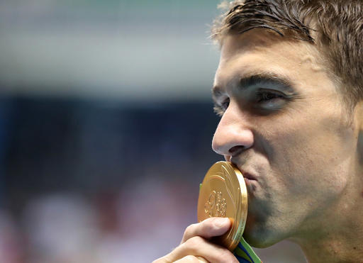 Winner United States Michael Phelps celebrates with his gold medal after the men's 200-meter butterfly during the swimming competitions at the 2016 Summer Olympics Tuesday Aug. 9 2016 in Rio de Janeiro Brazil. AP