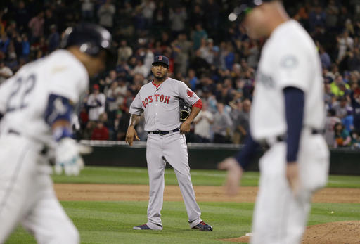 Boston Red Sox pitcher Fernando Abad center watches as Seattle Mariners&#039 Robinson Cano left is greeted by third-base coach Manny Acta after Cano hit a a three-run home run during the eighth inning of a baseball game Tuesday Aug. 2 2016 in Sea