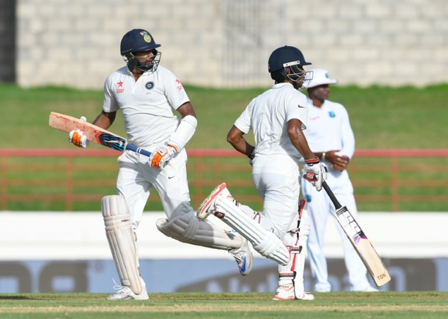 Ravichandran Ashwin and Wriddhiman Saha of India partnership during day 1 of the 3rd Test between West Indies and India