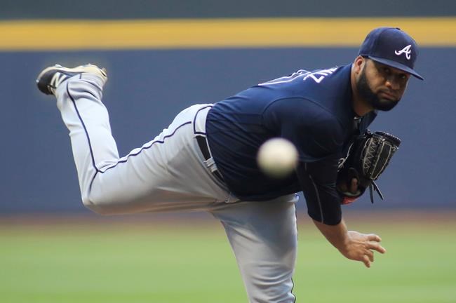 Atlanta Braves pitcher Joel De La Cruz throws to a Milwaukee Brewers batter during the first inning of a baseball game Wednesday Aug. 10 2016 in Milwaukee