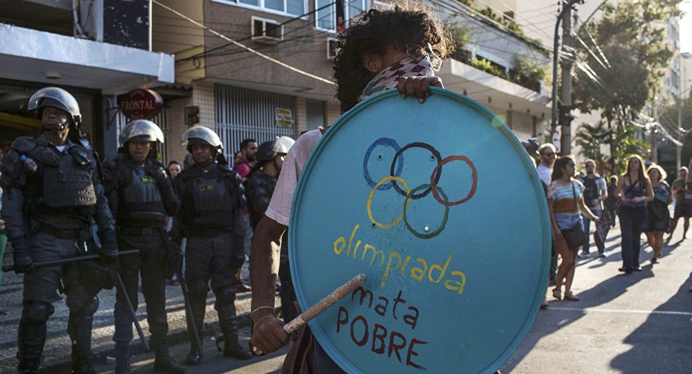 016 Rio Olympics- Opening Ceremony- Maracana- Rio de Janeiro Brazil- 05/08/2016. Protester stands in front of riot police during demonstration against the Olympic Games near the Maracana stadium