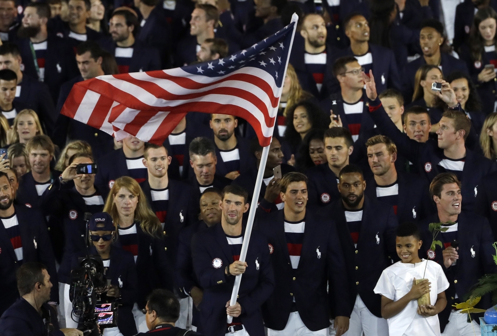 Michael Phelps carries the flag of the United States during the opening ceremony for the 2016 Summer Olympics in Rio de Janeiro Brazil Friday Aug. 5 2016. ORG XMIT OLY304