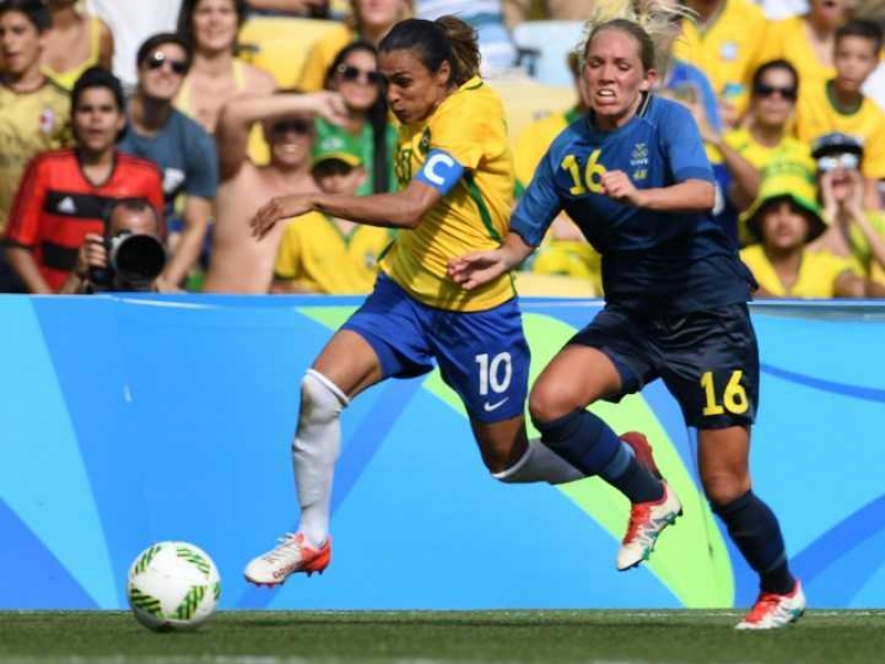 Brazil's Marta vies for the ball with Sweden's Elin Rubensson during their semifinal