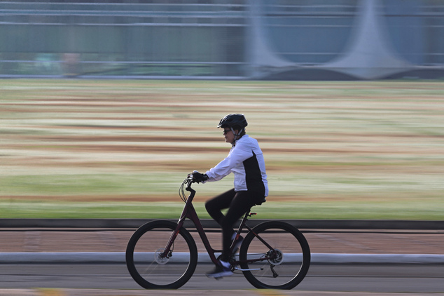 Brazil's suspended President Dilma Rousseff rides her bicycle in front of the official residence Alvorada Palace in Brasilia Brazil Monday morning Aug. 1