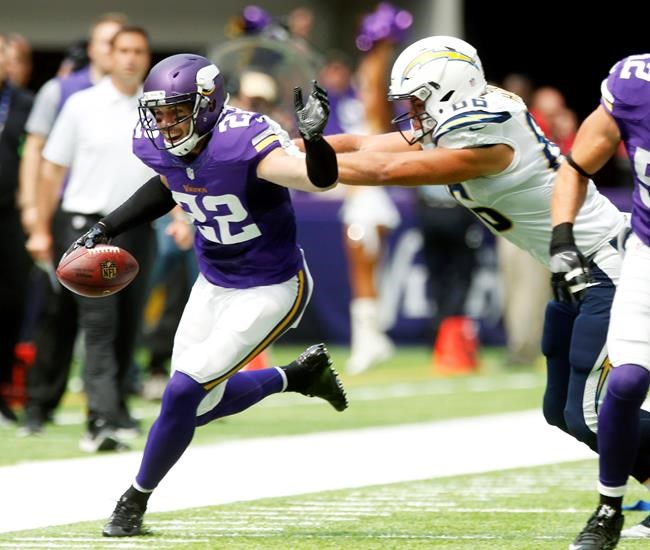 Minnesota Vikings free safety Harrison Smith runs from San Diego Chargers tight end Hunter Henry right after intercepting a pass during the first half of an NFL preseason football game Sunday Aug. 28 2016 in Minneapolis