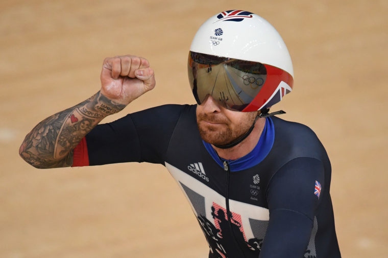 Britain's Bradley Wiggins celebrates after setting a world record after competing with teammates in the men's Team Pursuit qualifying track cycling event at the Velodrome in Rio