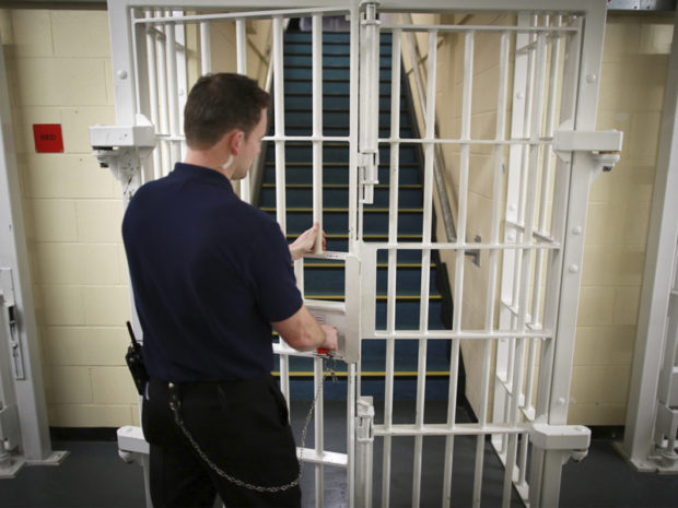 A prison guard locks a door in Britain. Reuters