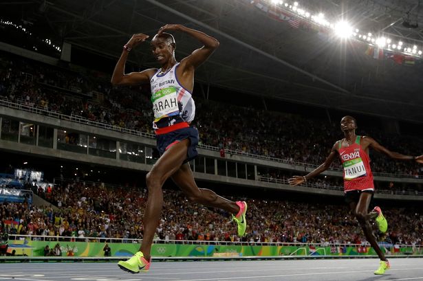 Britain's Mo Farah crosses the line to win gold