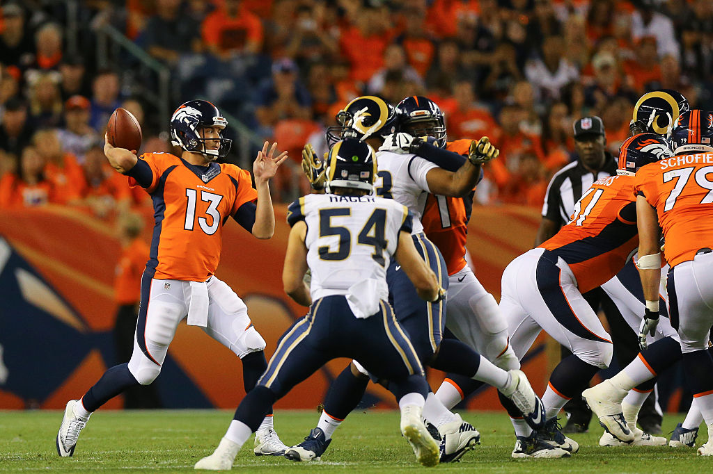 DENVER CO- AUGUST 27 Quarterback Trevor Siemian #13 of the Denver Broncos throws a pass during the second quarter against the Los Angeles Rams at Sports Authority Field Field at Mile High