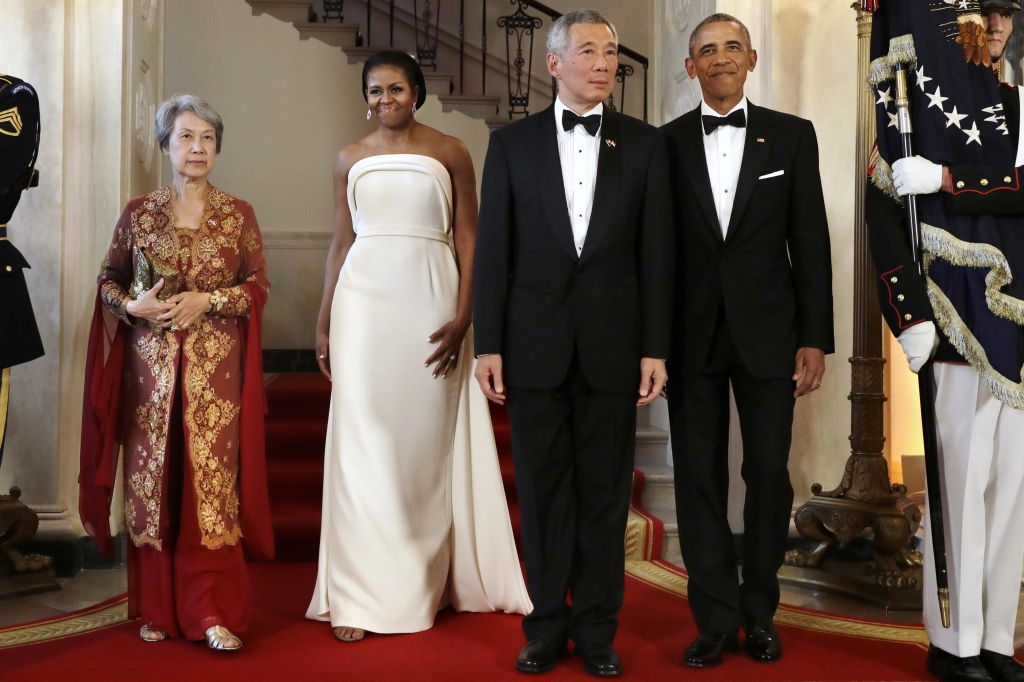 President Barack Obama right and Singapore's Prime Minister Lee Hsien Loong are joined by their wives Ho Ching at left and first lady Michelle Obama for