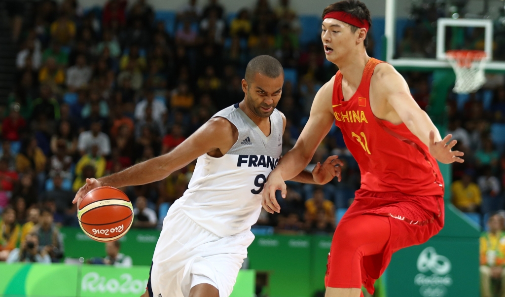 RIO DE JANEIRO BRAZIL- AUGUST 08 Tony Parker #9 of France drives the ball around Zhelin Wang #31 of China in the men's preliminary round group A game 19 on Day 3 of the Rio 2016 Olympic Games at the Carioca Arena 1