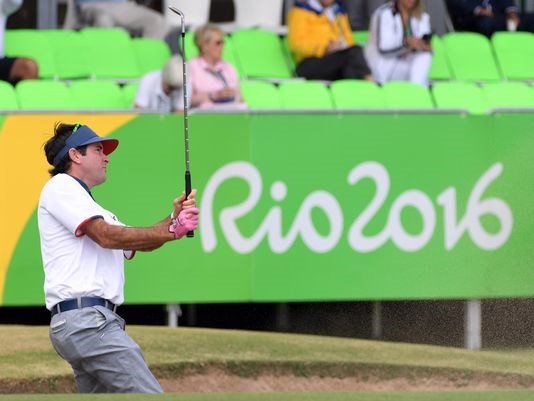 Bubba Watson plays from the sand on the 18th hole