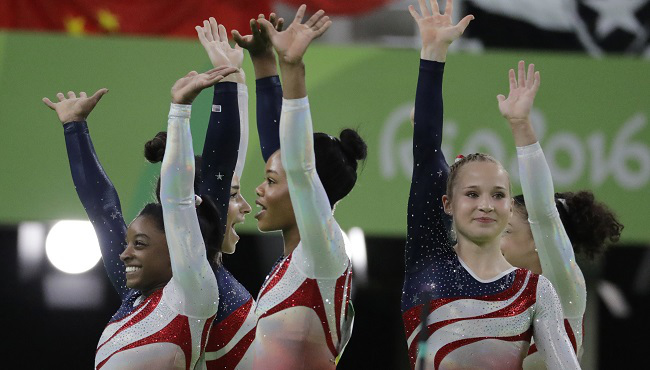 U.S. gymnasts left to right Simone Biles Aly Raisman Gabrielle Douglas and Madison Kocian wave to the audience at the end of the artistic gymnastics women's team final at the 2016 Summer Olympics in Rio de Janeiro Brazil Tuesday Aug. 9 2016