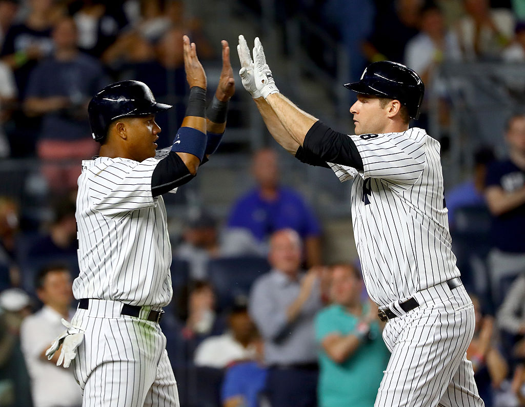 Starlin Castro #14 of the New York Yankees celebrates with teammate Chase Headley #12 after Headley hit a two run home run in the eighth inning