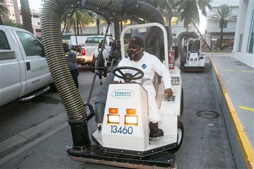 A City of Miami Beach Sanitation worker gets ready to clean the alleyways of South Beach sucking up still waters and debris with a mobile vacuum Friday Aug. 19 2016 Miami Beach Fla. as part of the city's Zika clean-up. (C.M. Guerrero  El Nuevo Heral