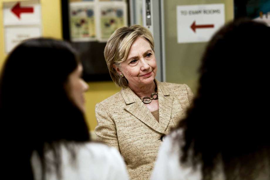 Hillary Clinton the Democratic presidential nominee greets members of the staff as she tours the Borinquen Health Care Center in Miami on Tuesday. A new batch of State Department emails released Tuesday showed the close and sometimes overlapping interes