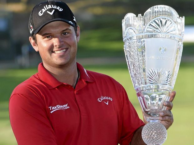 CUP LEADER Patrick Reed smiles as he holds the The Barclays trophy