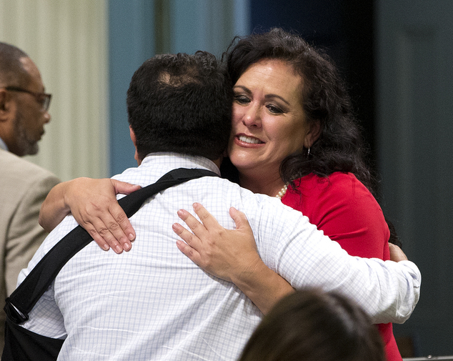 Assemblywoman Lorena Gonzalez D San Diego receives congratulations from Assemblyman Jimmy Gomez D Los Angeles after the Assembly approved her bill requiri