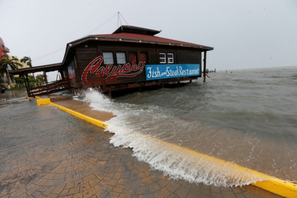 A wave splashes onto a restaurant along the beach after Hurricane Earl hit Belize City Aug. 4