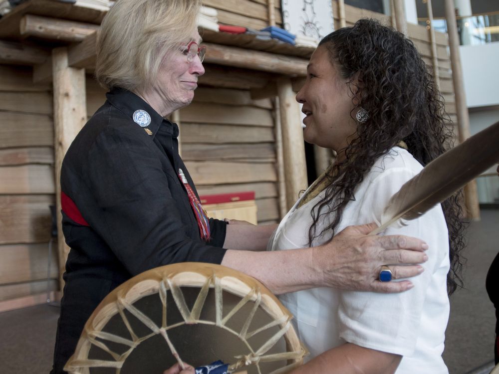 After the announcement of the terms for the inquiry Indigenous Affairs Minister Carolyn Bennett embraces Ceejai Julian who has lost two sisters