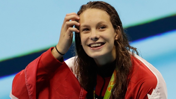 Penny Oleksiak celebrates winning gold