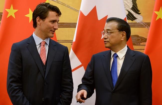 Canadian Prime Minister Justin Trudeau chats with the Premier of the People's Republic of China Li Keqiang during a signing ceremony for several tentative agreements in Beijing China on Wednesday