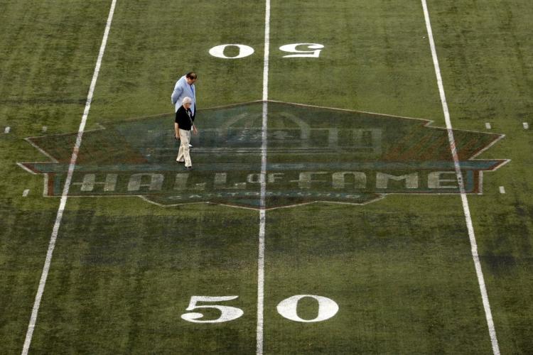 Pro Football Hall of Fame president David Baker looks over the turf after the Hall of Fame Game is canceled on Sunday night due to unsafe playing conditions