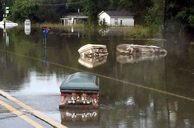 Caskets float along a submerged road in Louisiana after days of floodwater soddened graves