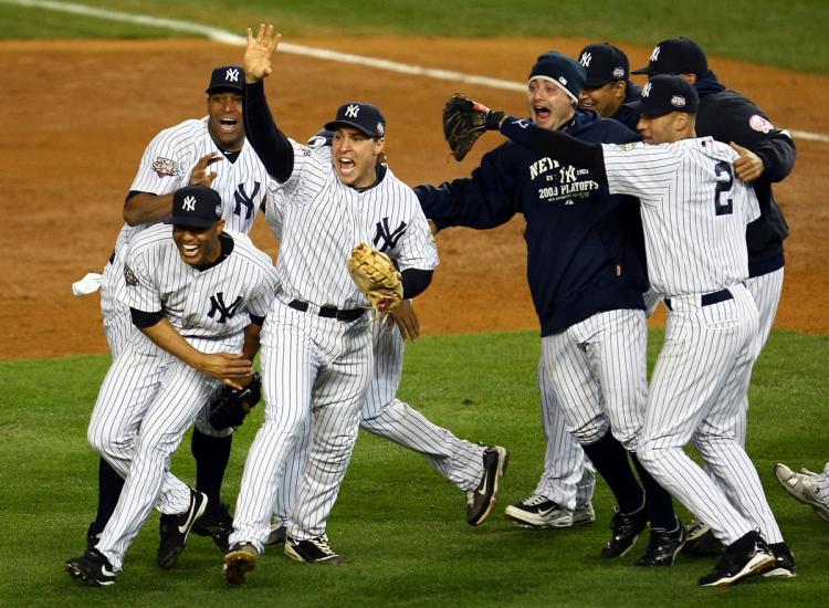 NEW YORK- NOVEMBER 04 Mariano Rivera #42, Mark Teixeira #25 and Derek Jeter of the New York Yankees celebrate with teammates after their 7-3 win against the Philadelphia Phillies in Game Six of the 2009 MLB World Series at Yankee Stadium on Nove