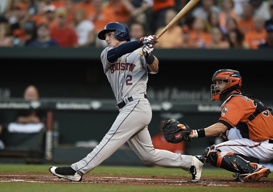 Houston Astros&apos Alex Bregman left follows through on a two-run home run against the Baltimore Orioles in the first inning Saturday. The Astros won 12-2