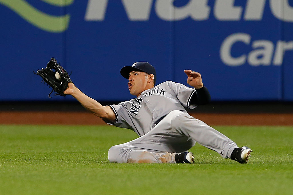 Center fielder Jacoby Ellsbury #22 of the New York Yankees makes a sliding catch