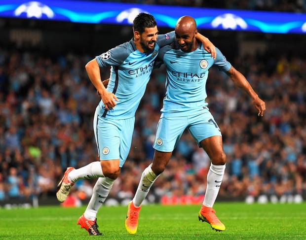 MANCHESTER ENGLAND- AUGUST 24 Fabian Delph of Manchester City celebrates scoring the opening goal with Nolito during the UEFA Champions League Play-off Second Leg match between Manchester City and Steaua Bucharest at Etihad Stadium