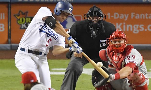 Los Angeles Dodgers&#039 Corey Seager left hits a solo home run as Philadelphia Phillies catcher Cameron Rupp right and home plate umpire Brian O'Nora watch during the seventh inning of a baseball game Monday Aug. 8 2016 in Los Angeles. (AP