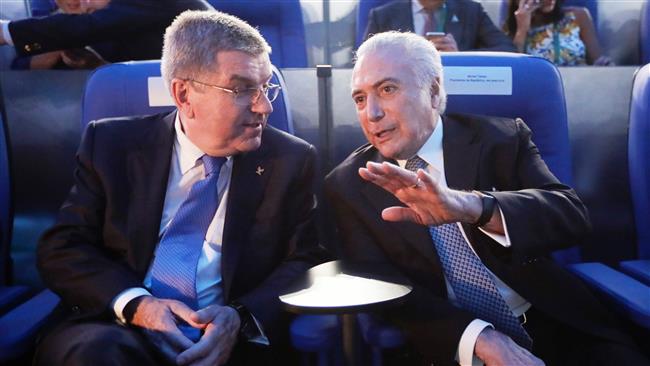 Brazil’s acting President Michel Temer speaks with Thomas Bach the president of the International Olympic Committee as they attend the opening ceremony of the Rio 2016 Olympic Games at the Maracana stadium in Rio de Janeiro Brazil