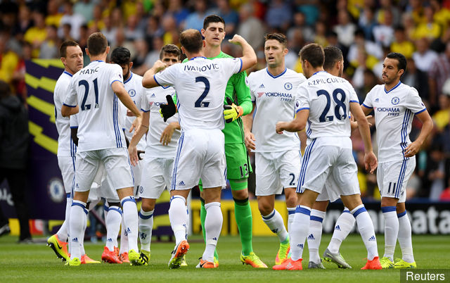 Chelsea's Thibaut Courtois and Branislav Ivanovic hug before the match