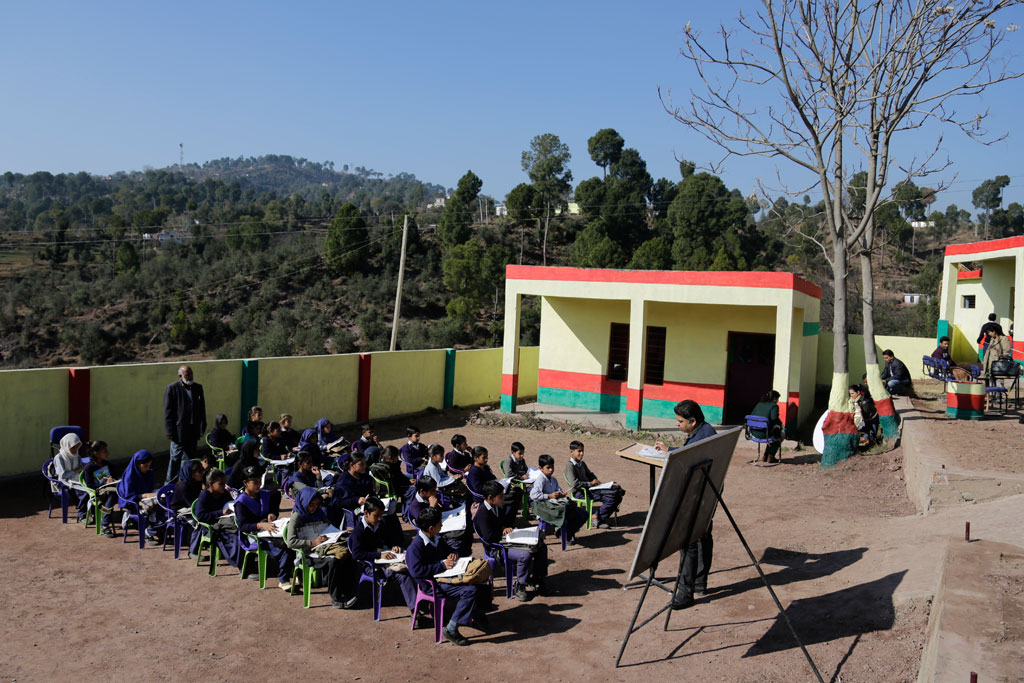 Children attend class in open at a government middle school Karian district Rajouri Jammu and Kashmir India