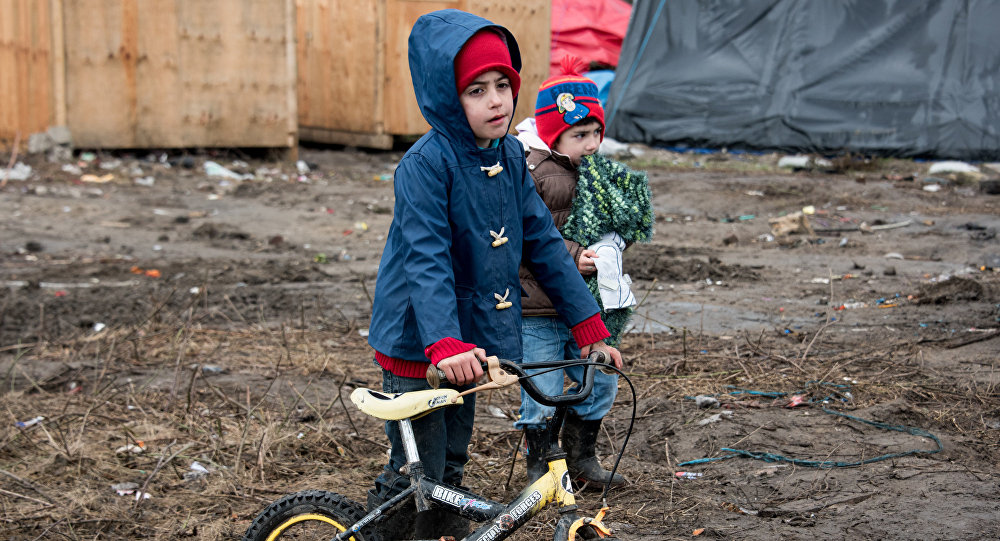 Migrant children play in the southern part of the so-called'Jungle migrant camp in Calais northern France